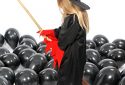 Halloween party with child in witch costume and broom
