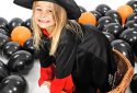funny young girl in witch costume for Halloween