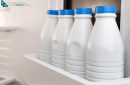 Four bottle milk stored and aligned in the fridge door