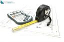 Architectural project concept with tape measure and calculator on construction project drawing plan