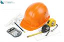 Construction safety helmet posing on paper blueprints, tape measure, pencil and calculator, isolated on white background