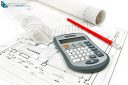 Calculator and pencil on house plan with rolls of architectural drawings