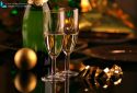 Close up of a bottle of champagne with two glasses and christmas ball
