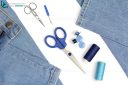 Tailor's tools for sewing with jeans and  scissors acut-out on white background