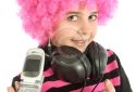 Young girl  with pink hair shows her old cellphone