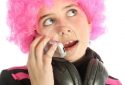 Young girl listening music and phoning with a vintage telephone