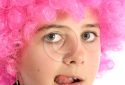 Portrait of girl with pink hair sticking out her tongue