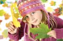 Autumnal mood of happy girl in yellow autumn leaves