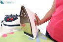 A steam iron on an ironing board and white background