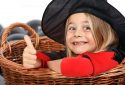 Portrait of a child in a witch costume, looking at the camera