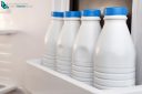 Four bottle milk stored and aligned in the fridge door