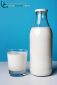 Full milk bottle with glass  for breakfast isolated on blue background