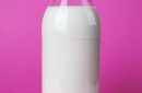 full milk bottle isolated on pink background