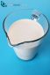 Full milk carafe isolated on blue background