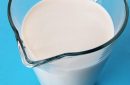 Full milk carafe isolated on blue background