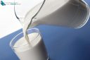 Pouring milk from jug into a glass