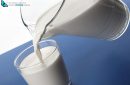 Pouring milk from jug into a glass