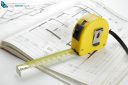 Yellow measuring tape on a construction plan