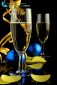 Close up of two champagne glasses, ribbon and confetti on black background