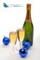 Two glasses of champagne and Christmas balls on white background