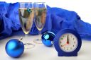 Two glasses of champagne with a clock and Christmas balls for the new year