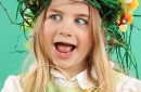 Cute little kid wearing fun hairstyle on the Easter day with basket of shiny eggs