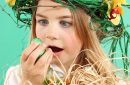 Easter celebration concept: young girl with basket of Easter eggs and a fun hairstyle