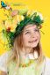 Smiling Happy Young Girl Wearing Headdress of Spring Flowers, Easter Eggs and Feathers.