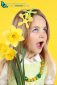 Spring concept: young girl on yellow background with daffodils