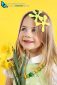Portrait little blonde girl on yellow background with spring daffodil flowers