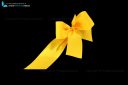 yellow bow and ribbon cut out and isolated on black background