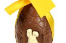 big chocolate egg with yellow ribbon and bow,  Easter bunny, isolated on white