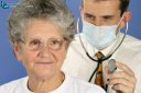 Doctor with stethoscope examines sick 65 year old patient in consultation