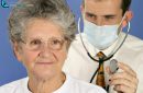 Doctor with stethoscope examines sick 65 year old patient in consultation