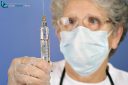 doctor preparing injection of COVID-19 vaccine for prevention of coronavirus with glass syringe and large needle