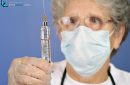 doctor preparing injection of COVID-19 vaccine for prevention of coronavirus with glass syringe and large needle