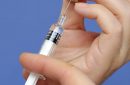 Nurse hands close-up holding preparing a syringe with a dose of coronavirus covid 19 vaccine