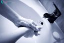 A woman respects the barrier gestures of decontamination of the COVID-19 virus and washes her hands with soap